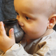 An infant drinks from a reconstructed feeding vessel similar to the ones analyzed in the new study.